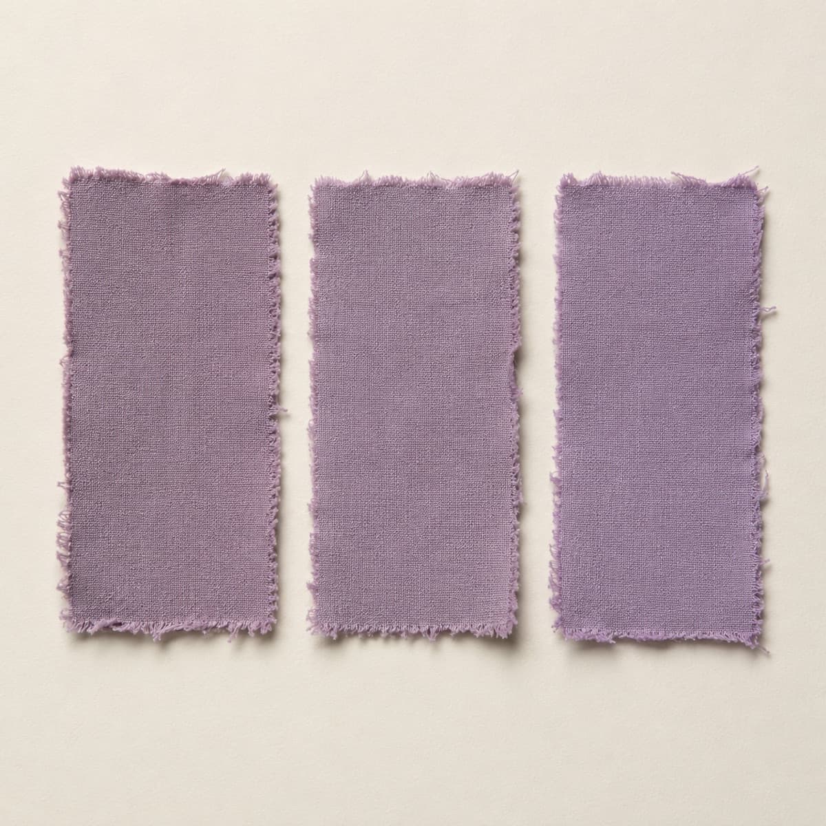 Three swatches of one colour from different dye lots laid side by side