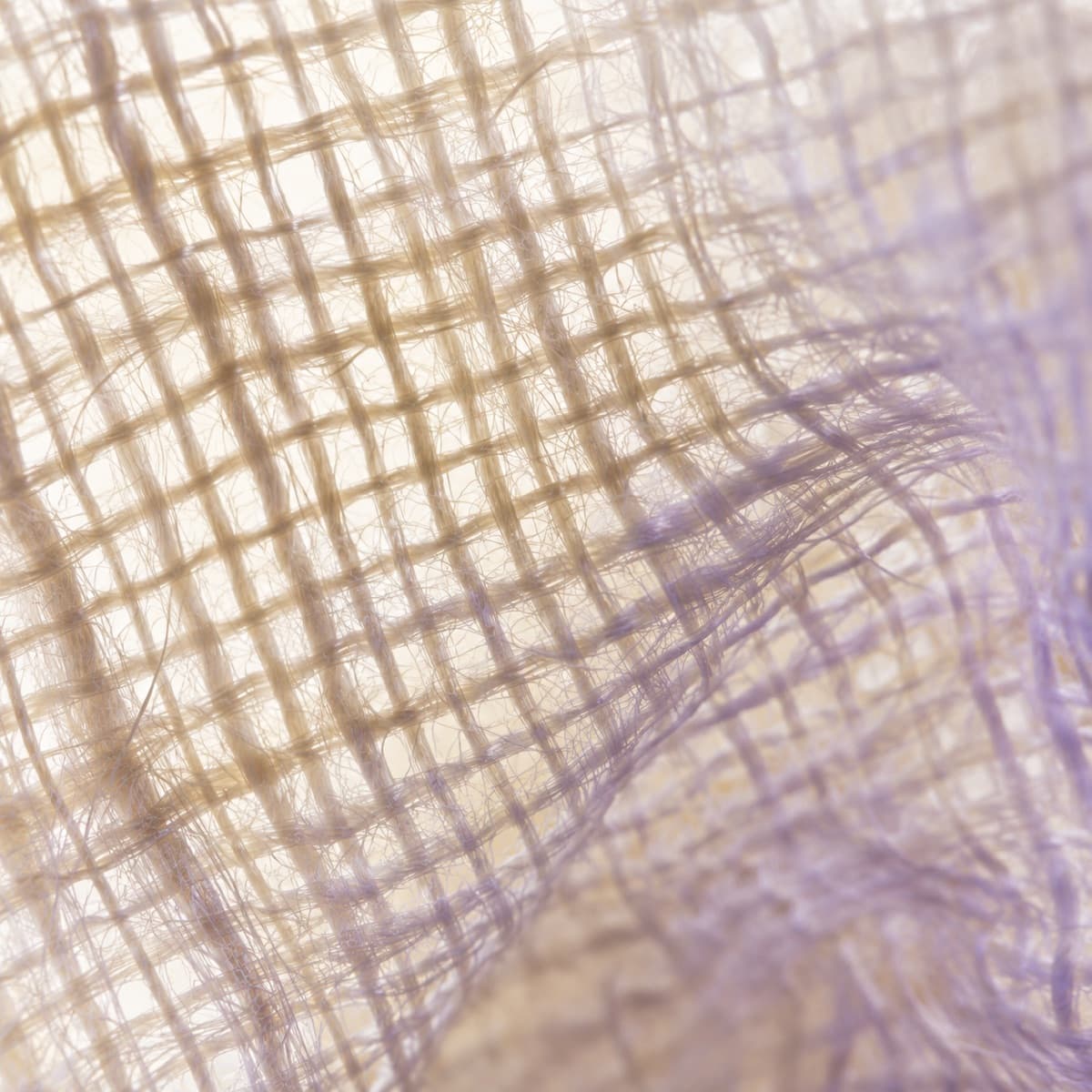 Macro photograph of open abaca sinamay weave, backlit
