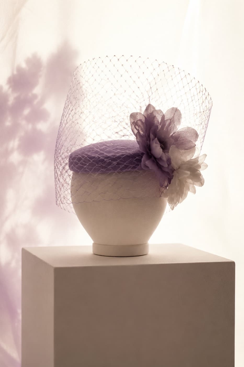 Short birdcage veil on a featureless display block